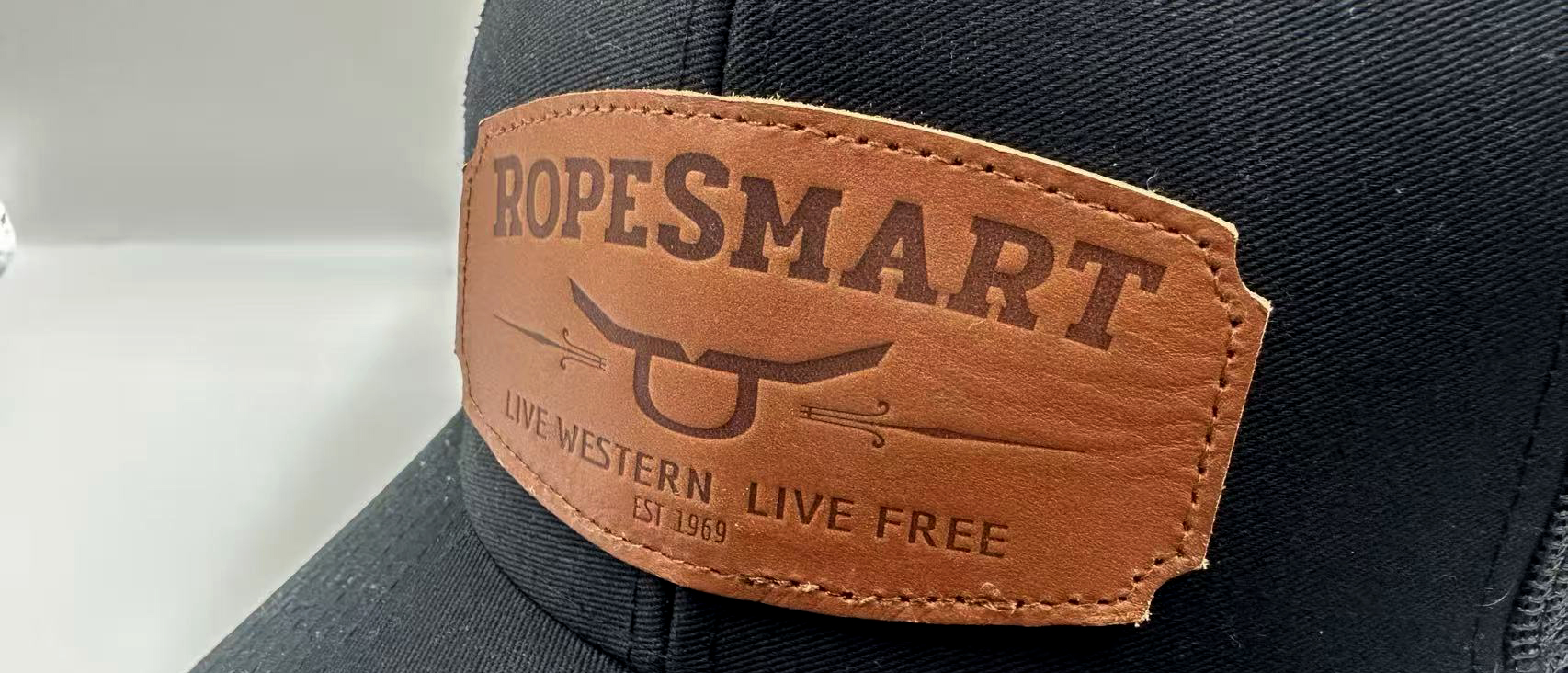 Laser-etched leather patch close-up showing grain texture and embossed branding detail