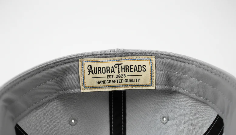 Custom woven label inside snapback hat showing brand details