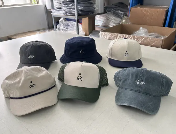 Custom hats manufactured by Anthea including baseball caps, rope hats, bucket hats, and trucker hats