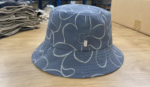Custom bucket hat with all-over print and woven label for streetwear brand