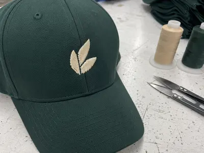 Custom hat embroidery close-up detail showing quality stitching by Anthea